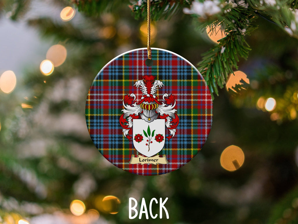 Lorimer ceramic ornament detail showing a double-sided family shield on a Caledonia tartan background