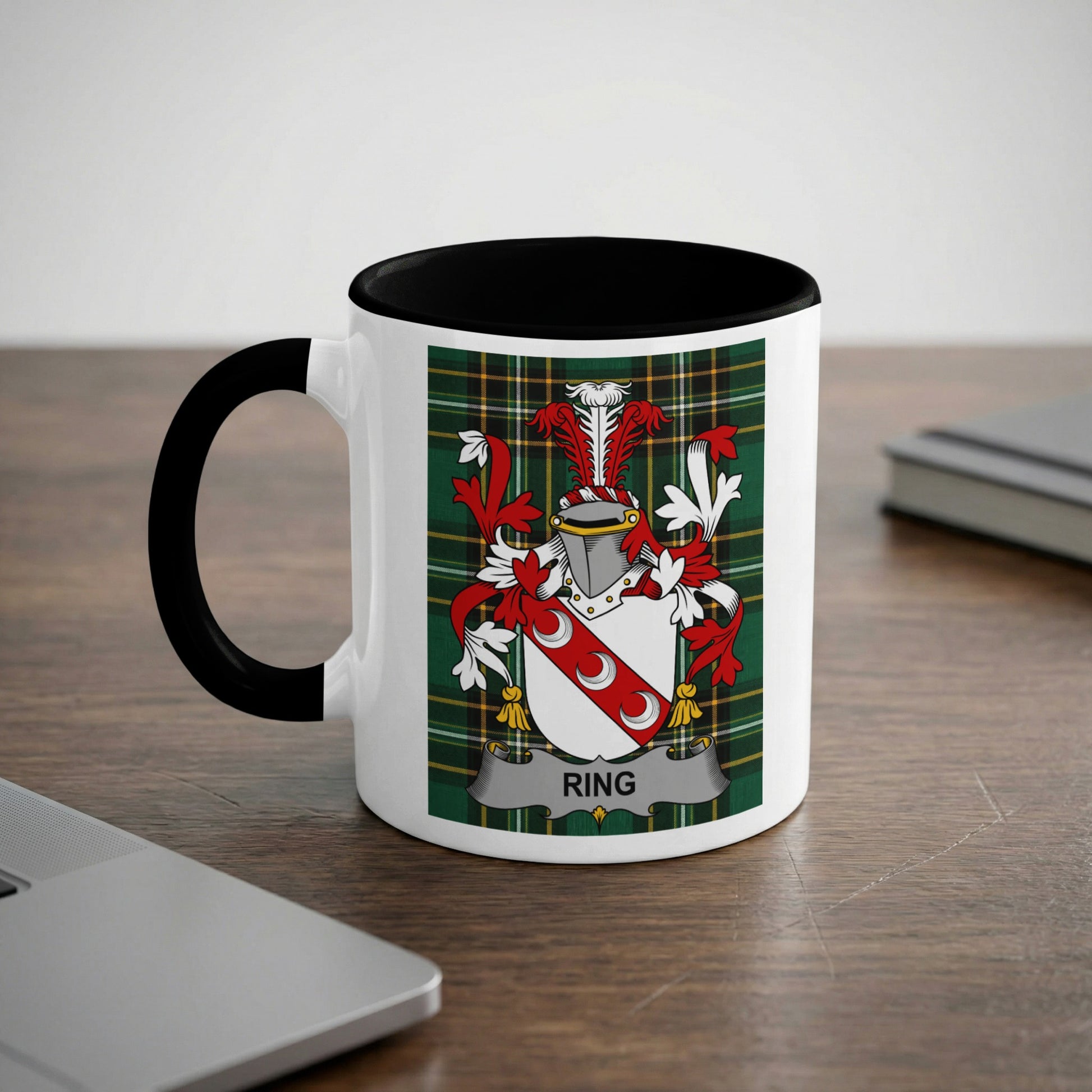 White mug with black rim displaying a family crest with the name "Ring".