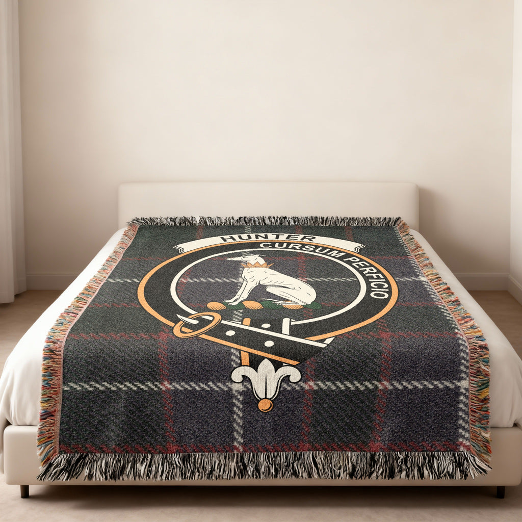 Hunter family crest and motto woven into tartan blanket — close-up