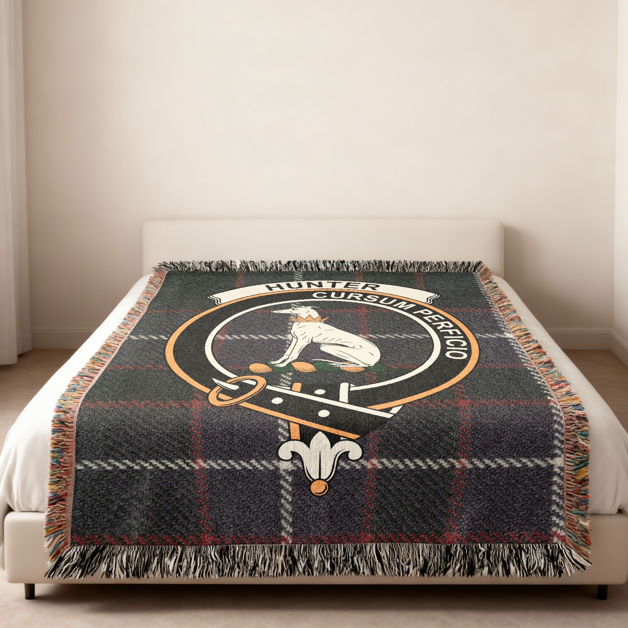 Hunter family crest and motto woven into tartan blanket — close-up