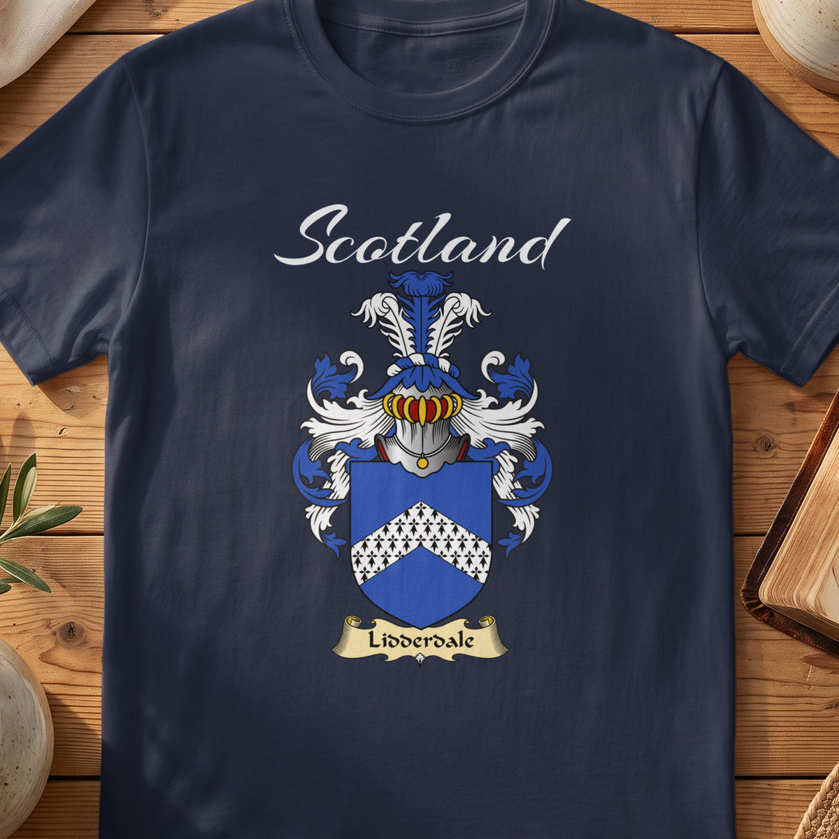 Navy Lidderdale family shield T-shirt featuring a white patterned chevron on blue