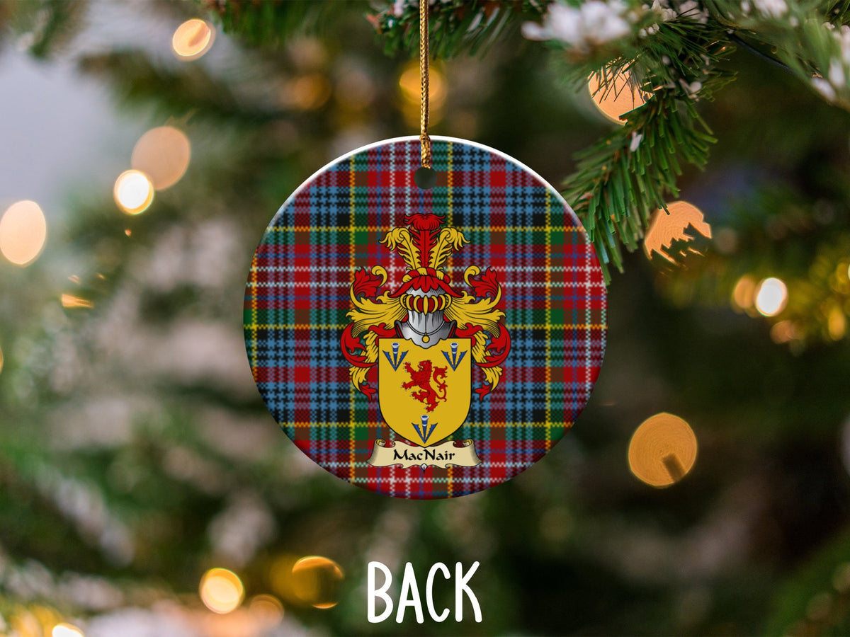 MacNair ceramic ornament detail showing a double-sided family shield on a Caledonia tartan background