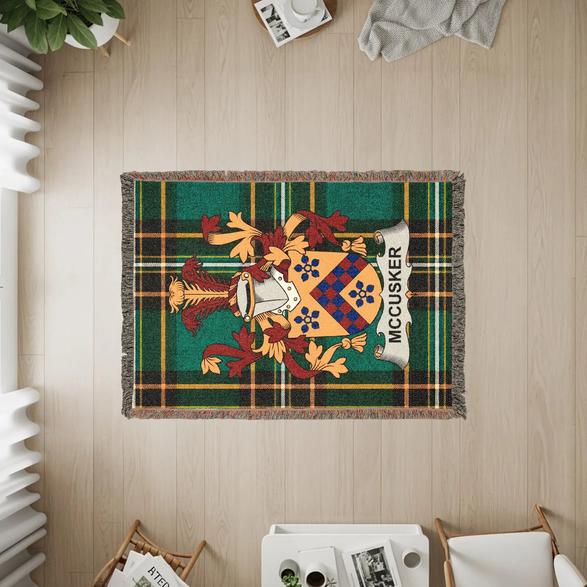 Green tartan blanket with McCUSKER family crest displayed.