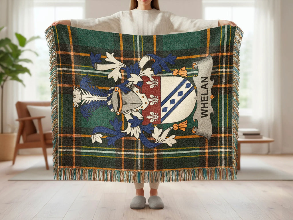 Tartan blanket with Whelan family crest held by person.