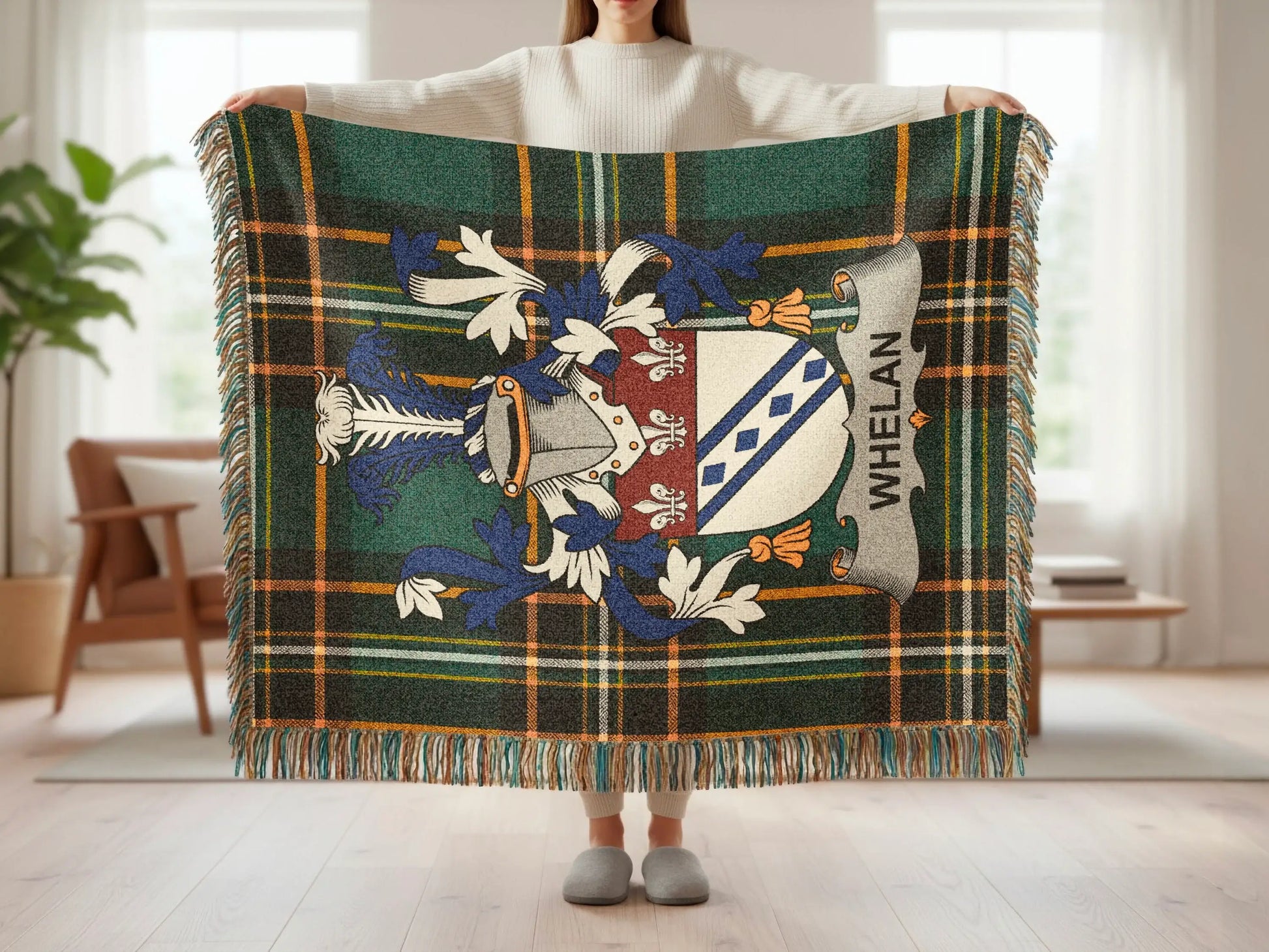 Tartan blanket with Whelan family crest held by person.