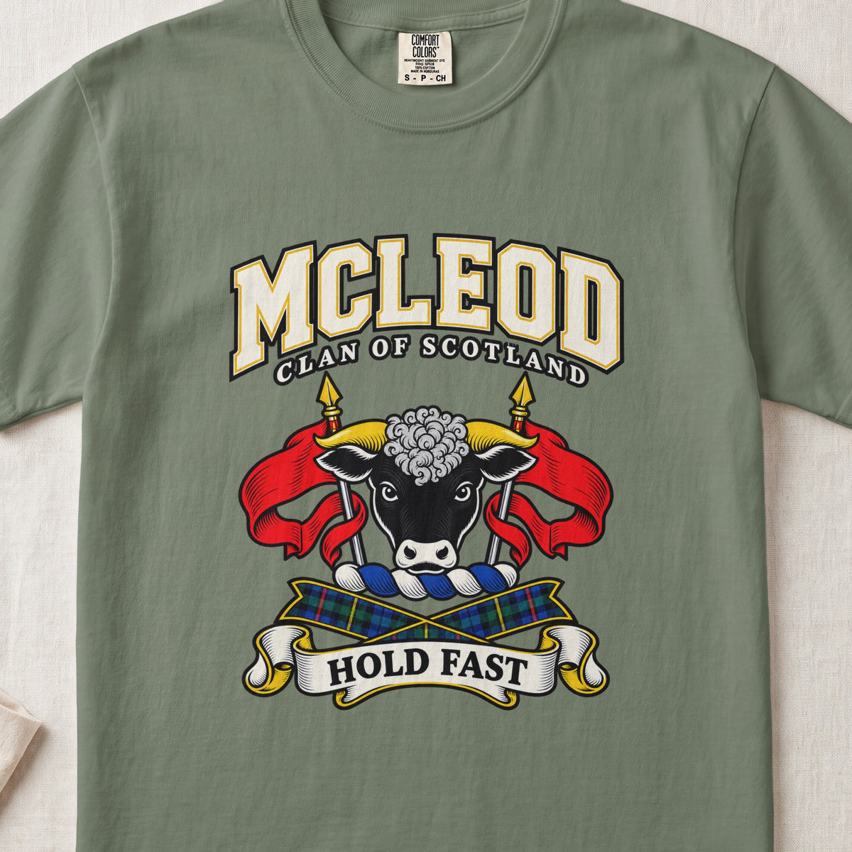 McLeod graphic T-shirt in Moss green, front flat lay showing varsity lettering and black bull head with white muzzle and curly white forelock.