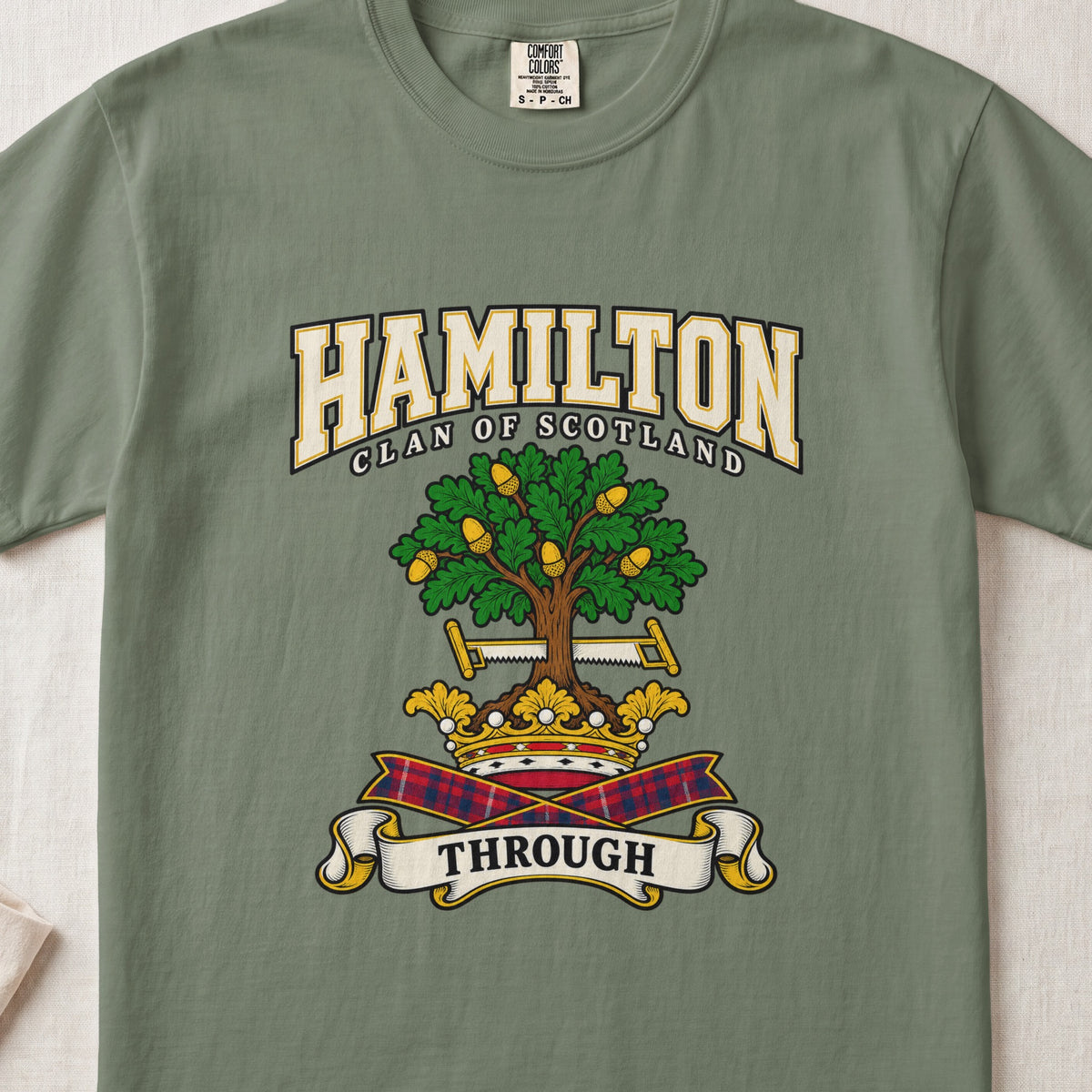 Hamilton graphic T-shirt in Moss green, front flat lay showing varsity lettering and green oak-like tree with gold acorns.