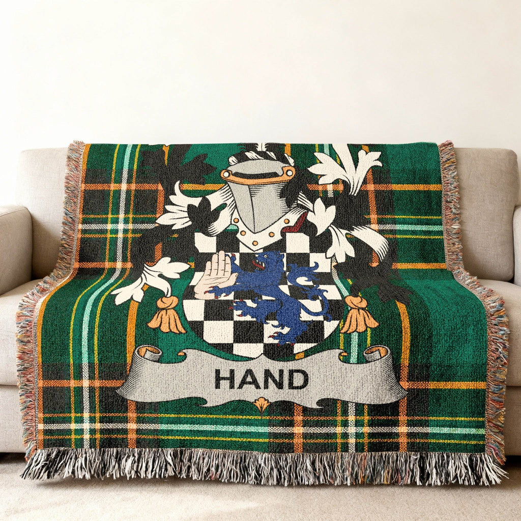 Green plaid woven throw blanket with the Hand family crest.
