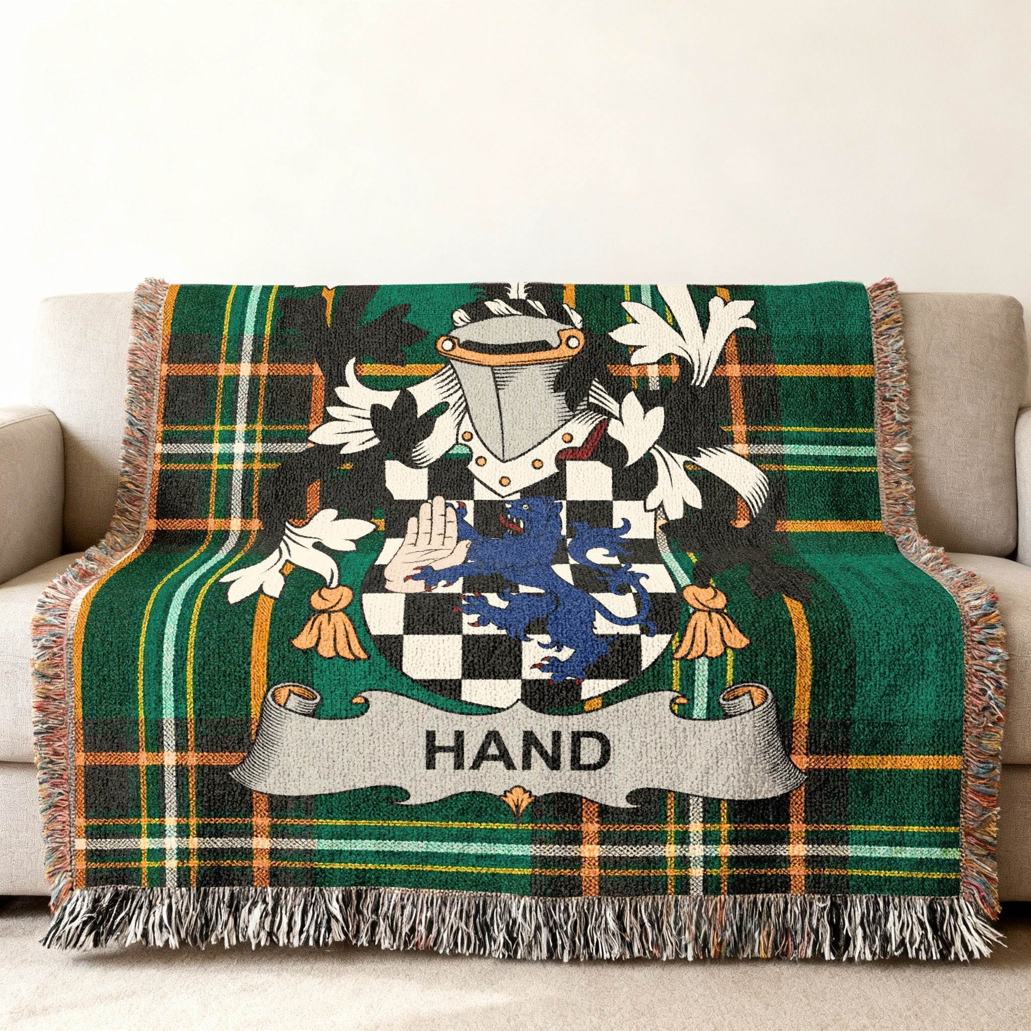 Green plaid woven throw blanket with the Hand family crest.