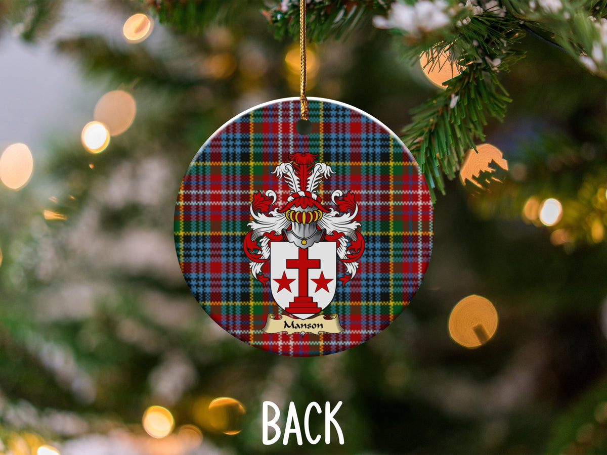 Manson ceramic ornament detail showing a double-sided family shield on a Caledonia tartan background