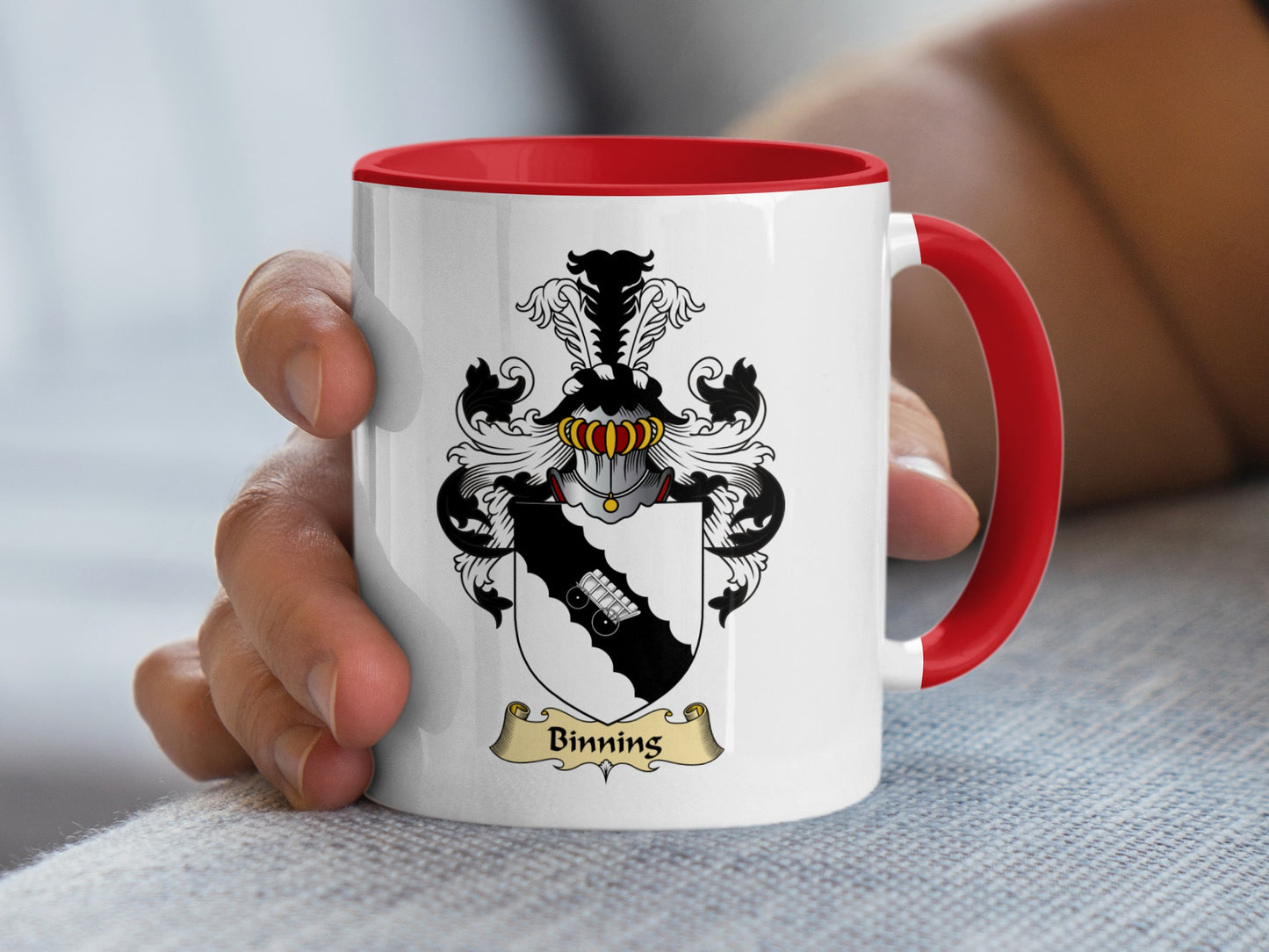 White mug with red handle featuring a family crest with the name "Binning".