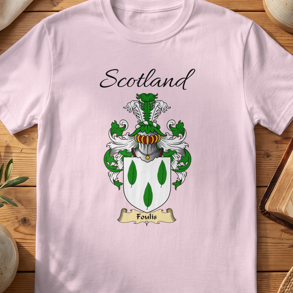 Light Pink Foulis Scottish family shield T-shirt featuring three green leaf shapes on white