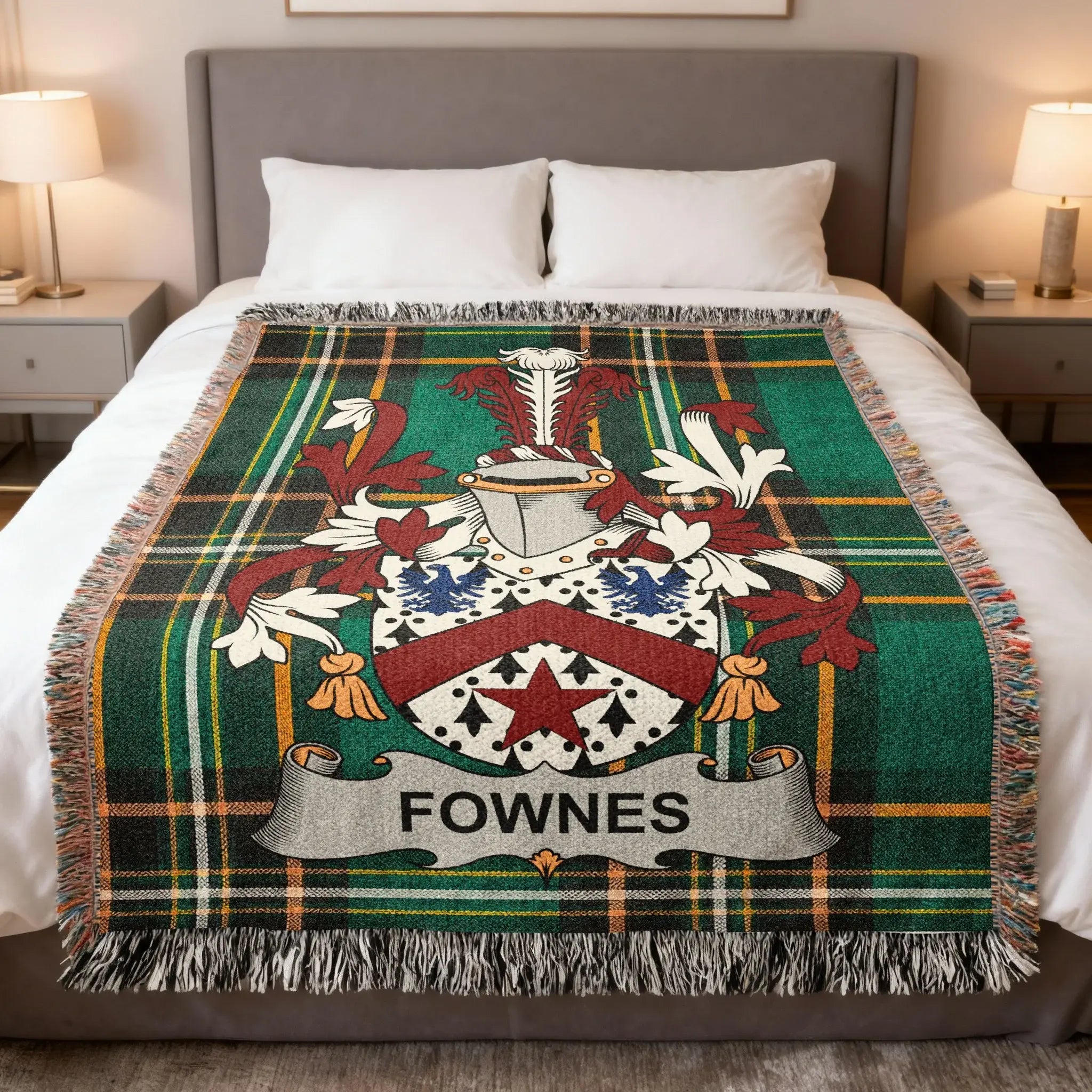 Tartan blanket with Fownes family crest displayed on a bed.