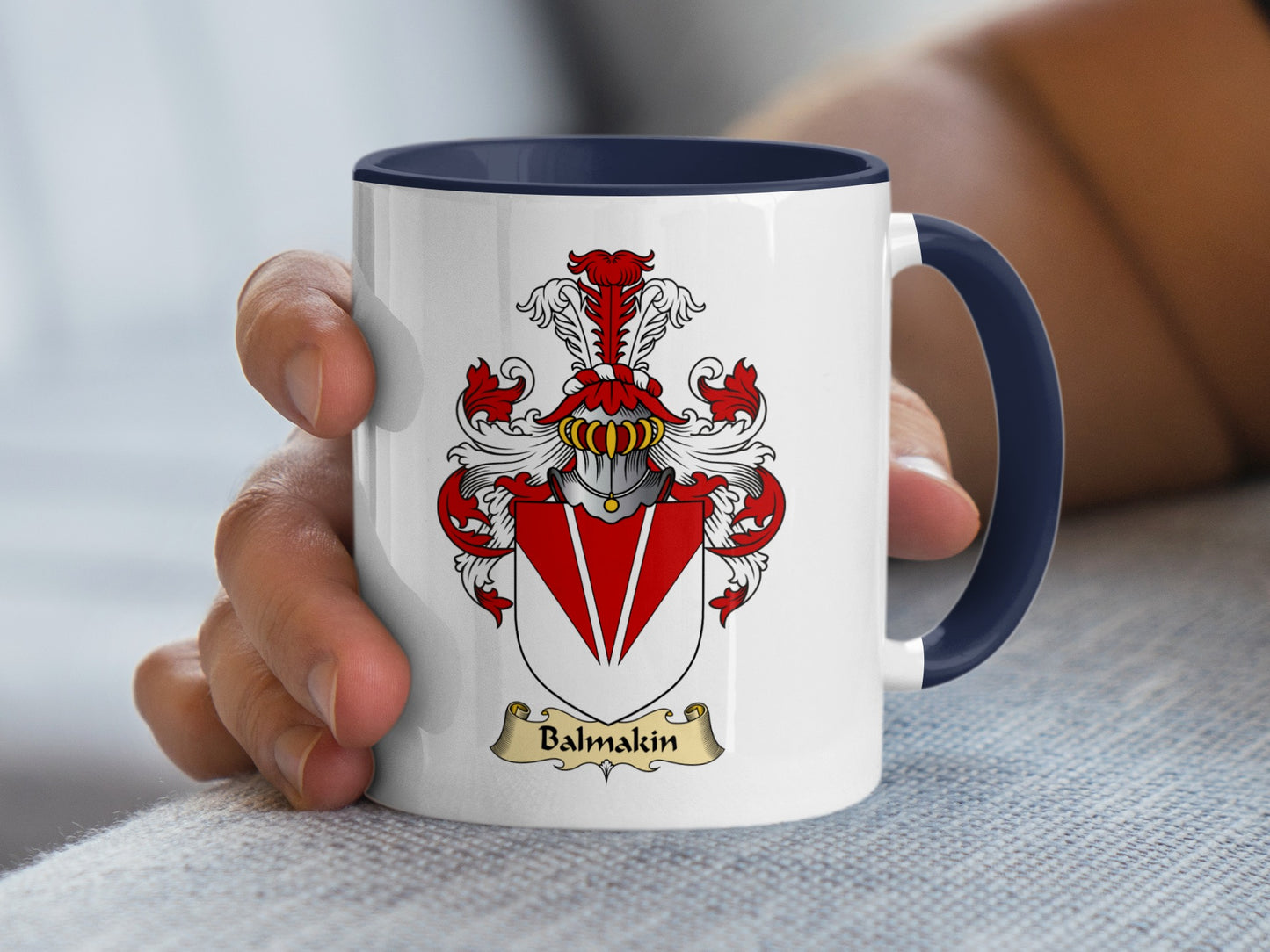 White ceramic mug with navy blue rim featuring a red and gold crest with "Balmakin" text.