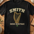 Smith Irish harp T-shirt in Black, with cream surname lettering, a gold-toned harp, green shamrock and “Irish Heritage” text.