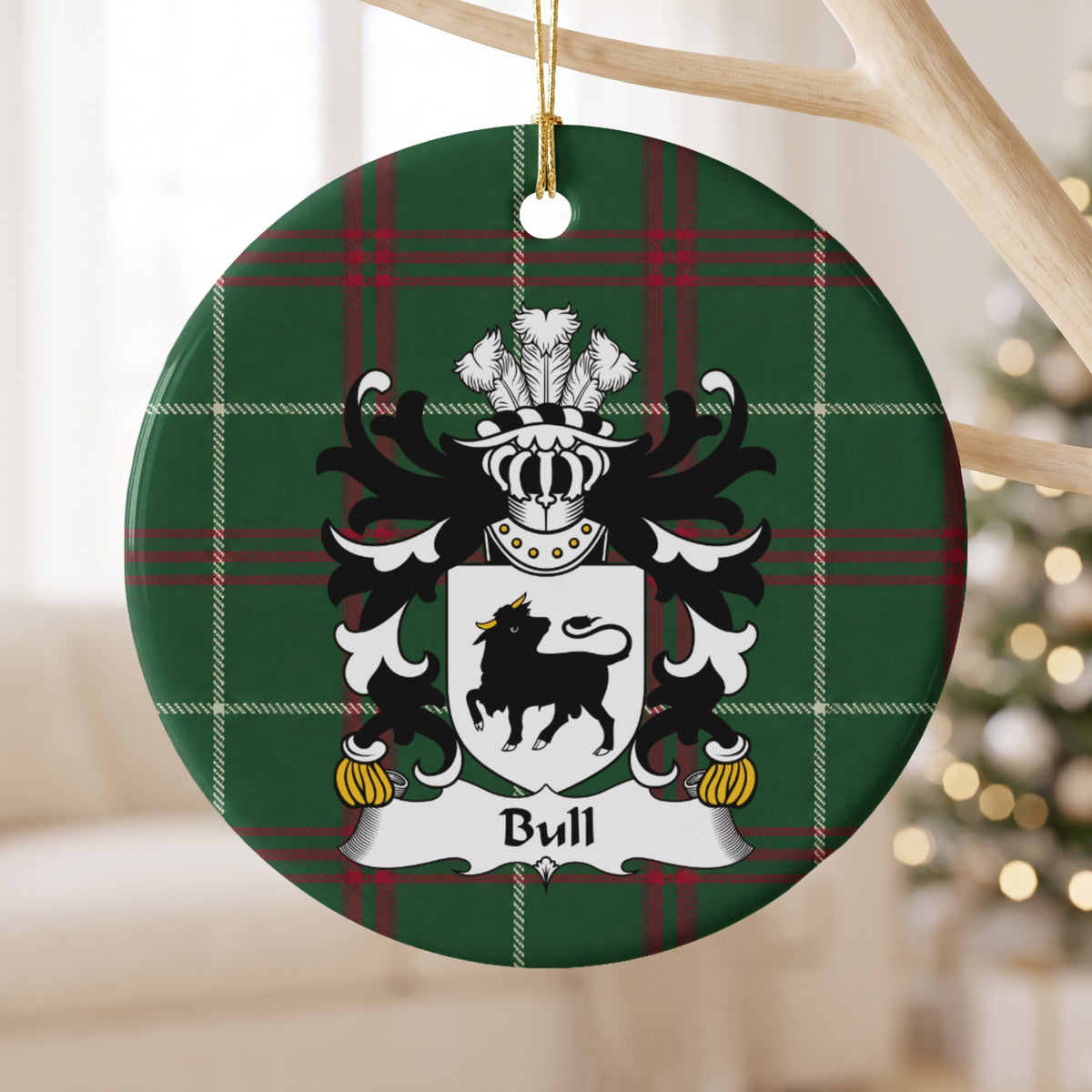 Bull ornament hanging from a pale wooden branch; a black bull with gold horns on a white shield on Welsh national tartan.
