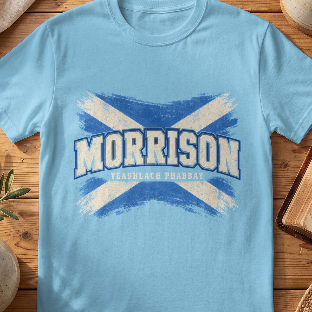Morrison Scottish Saltire T-shirt in Sky, with distressed blue and cream flag and “Teaghlach Phabbay” lettering.