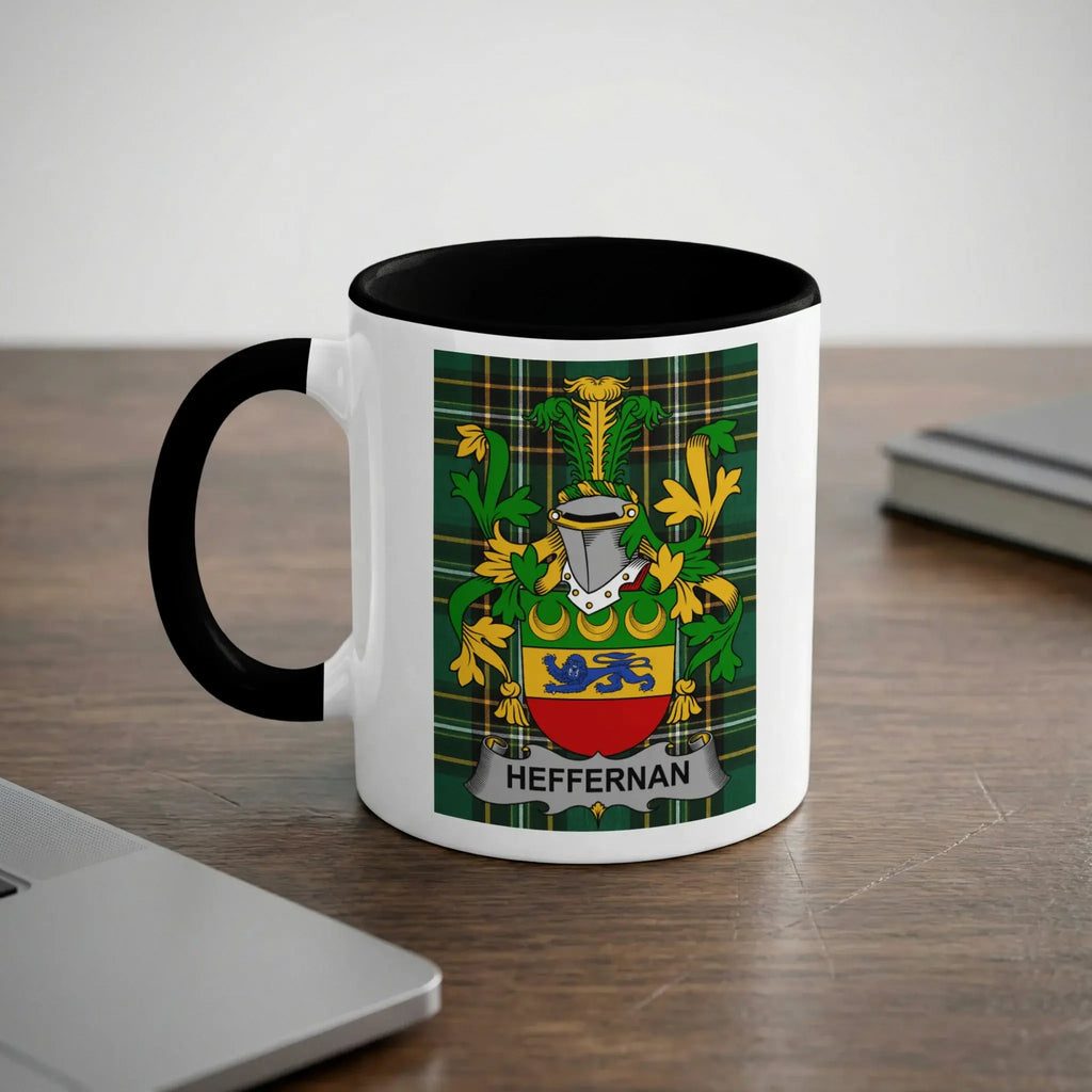 White mug with black handle and rim, displaying a green plaid shield with a blue lion and gold crown.