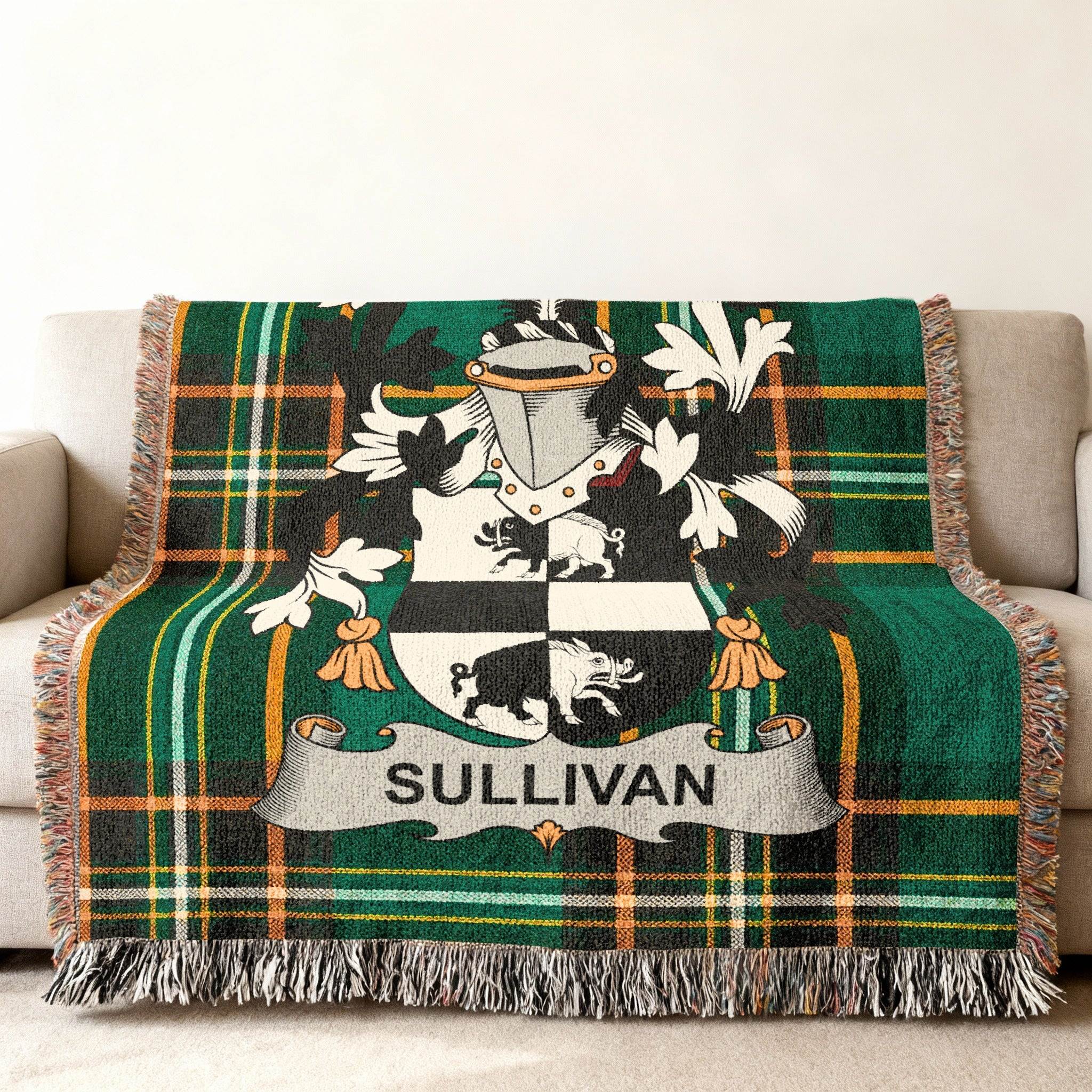 Green plaid throw blanket with Sullivan family crest displayed prominently.