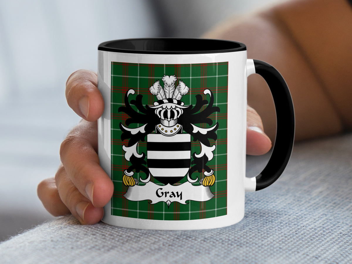 Mug with Gray family crest on a green tartan background.