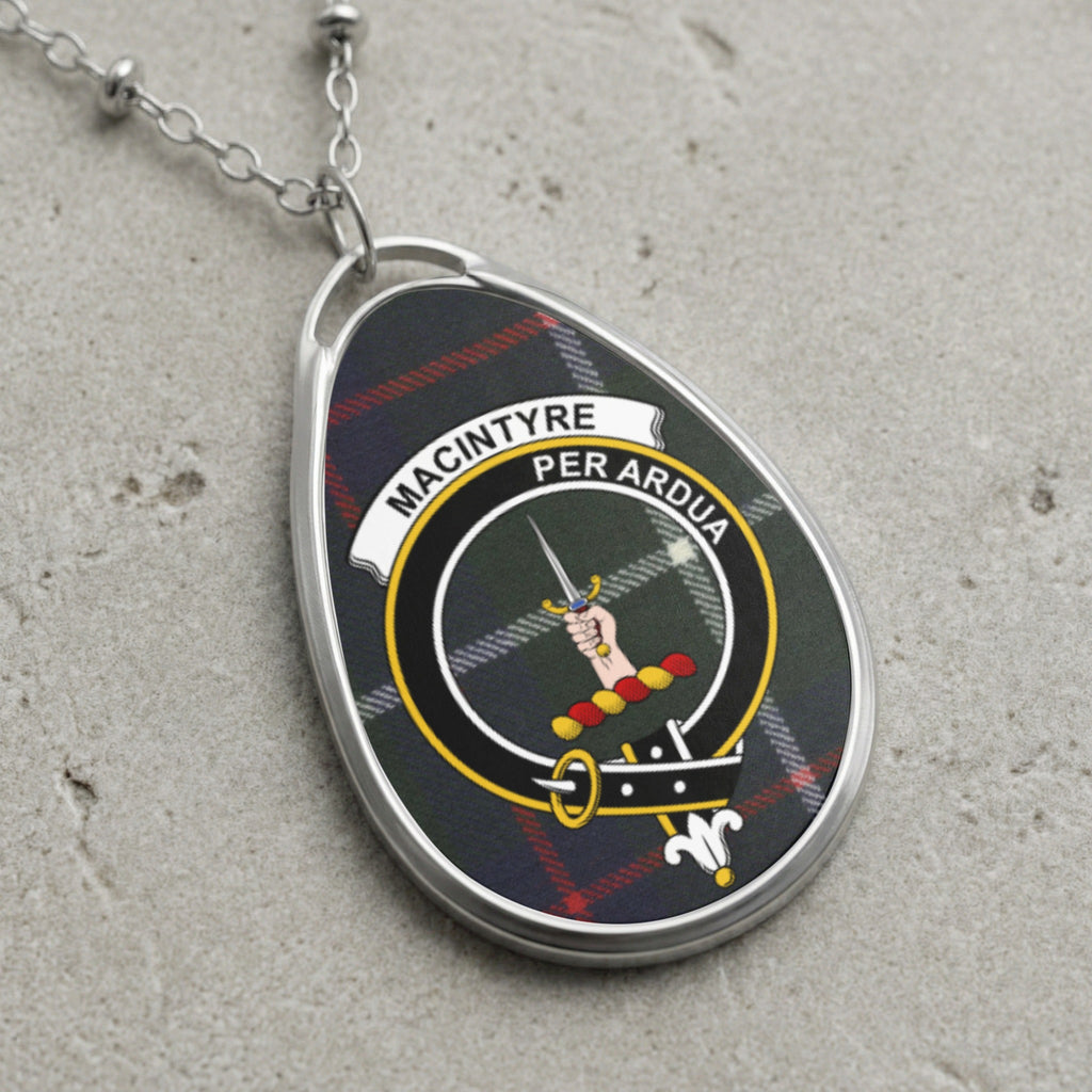 MacIntyre clan badge pendant with text "MACINTYRE PER ARDUA" on tartan.