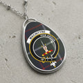 MacIntyre clan badge pendant with text "MACINTYRE PER ARDUA" on tartan.