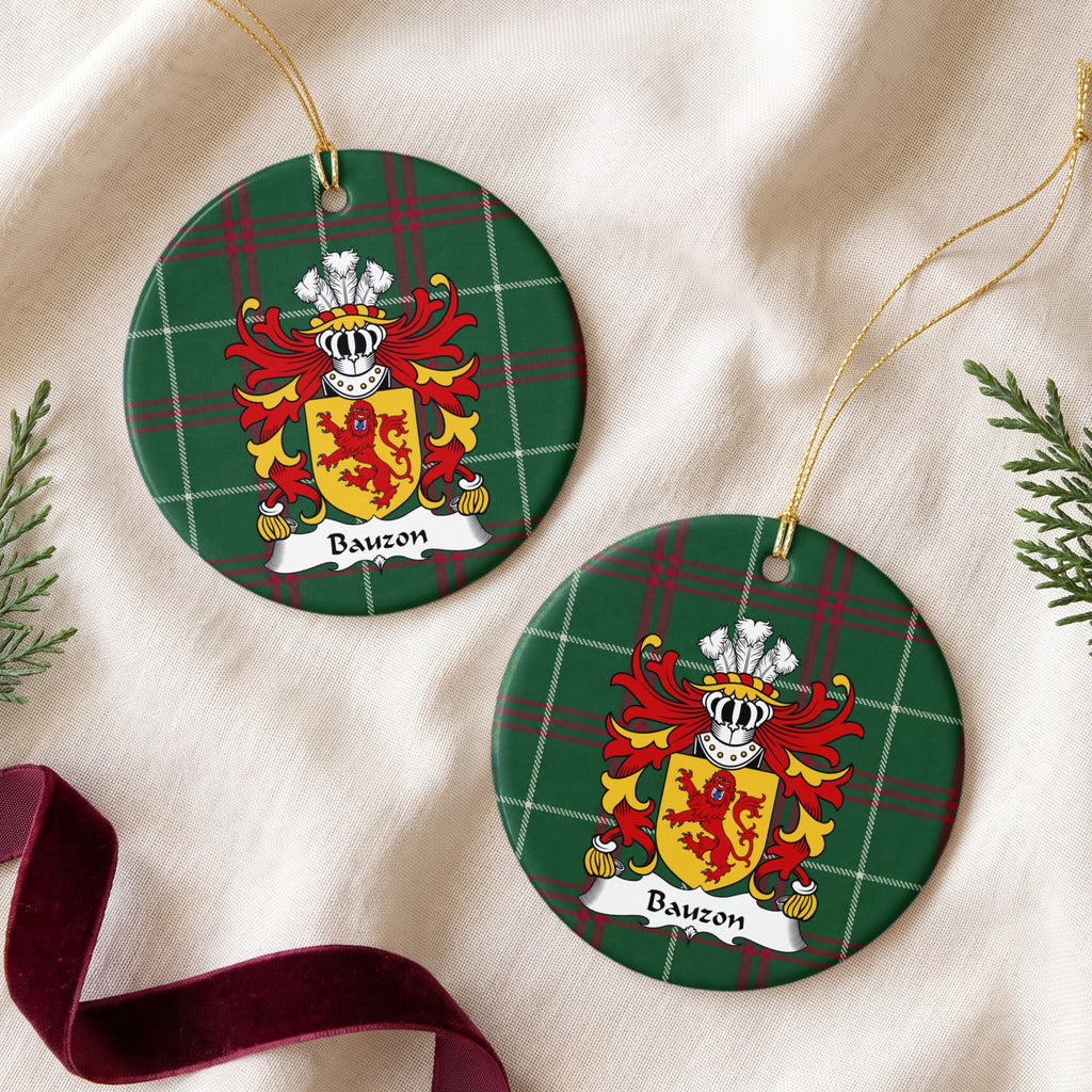 Two Bauzon ornaments on cream fabric beside evergreen and burgundy ribbon; a red upright lion facing forward on a gold shield on Welsh national tartan.