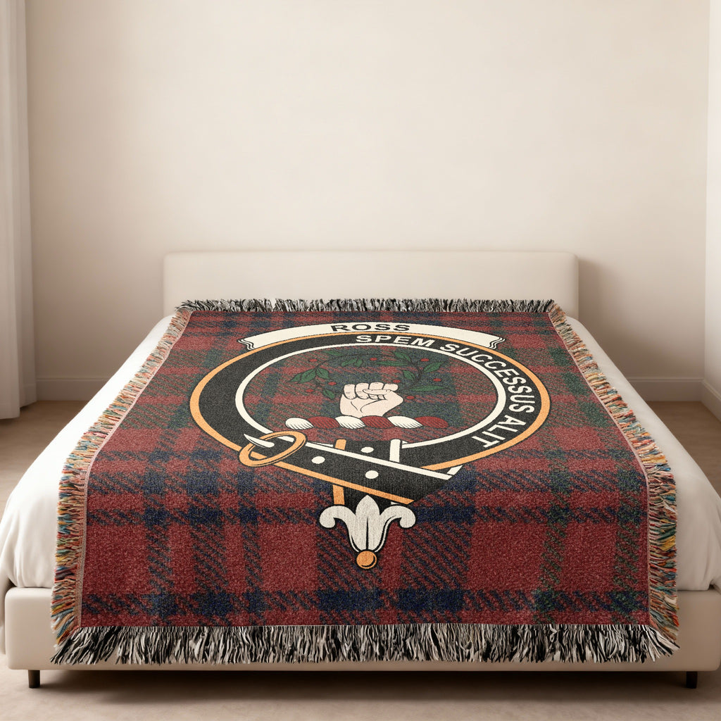Ross clan crest with Spem Successus Alit motto on tartan blanket on a bed