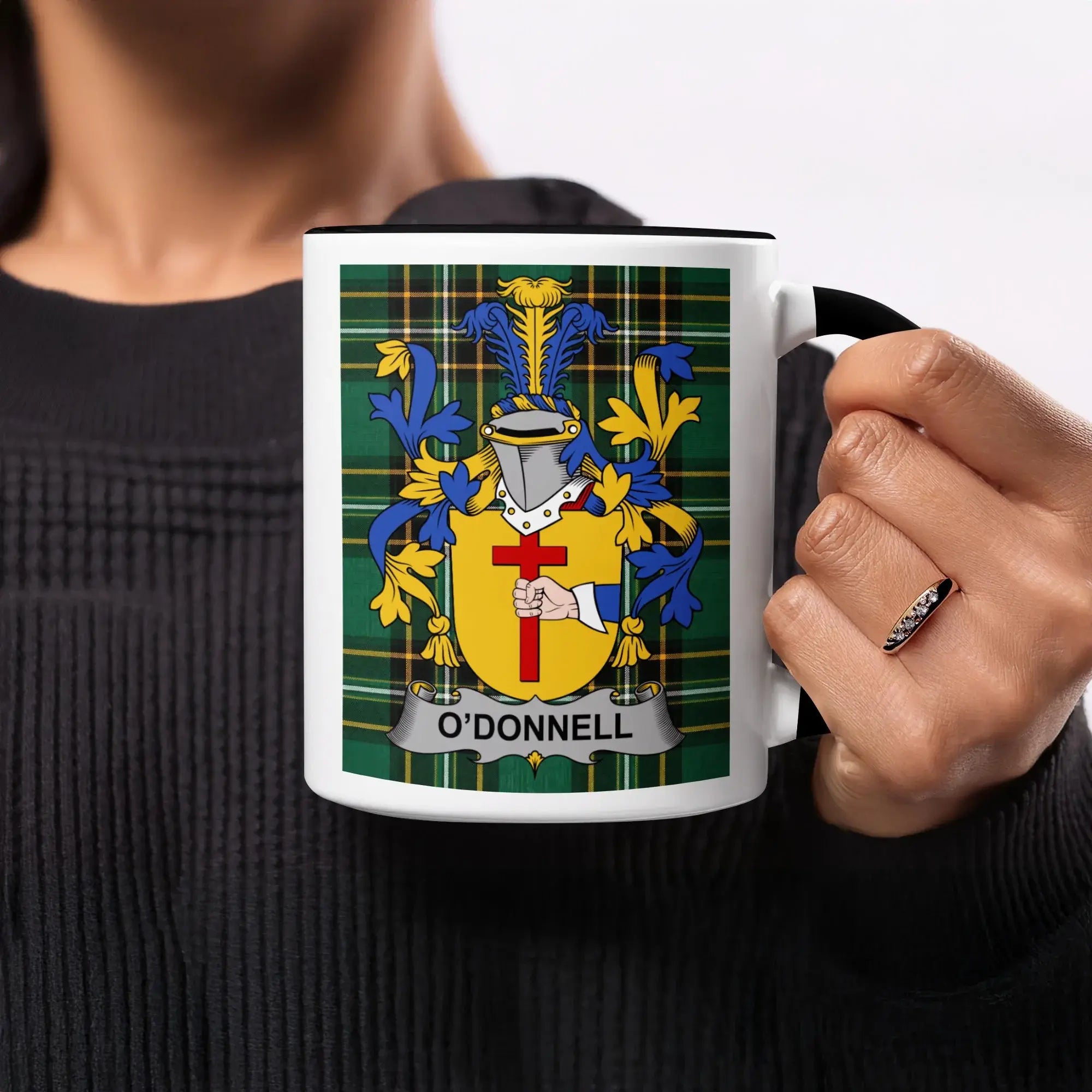 Black mug with O'Donnell family crest on a plaid background.