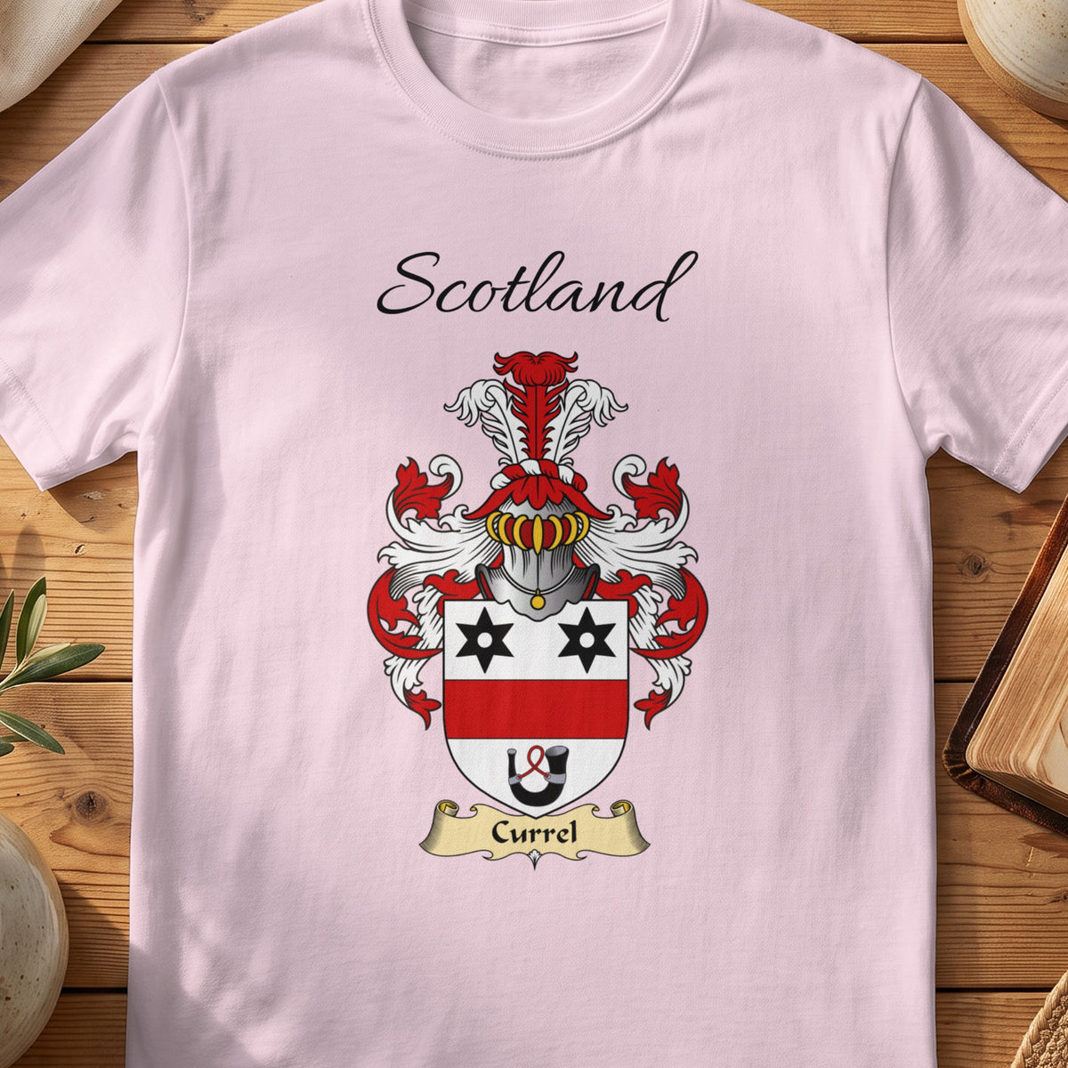 Light Pink Currel Scottish family shield T-shirt featuring black stars above a red band