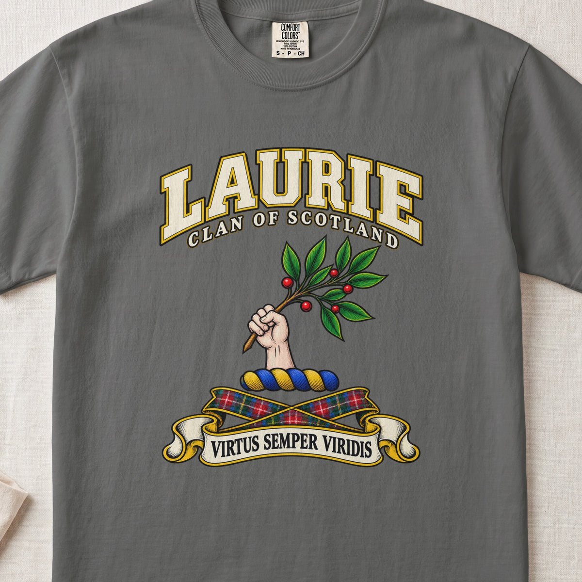 Laurie Scottish clan T-shirt in Pepper, front view with a hand holding a leafy branch with red berries and motto design.