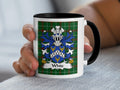 White family crest on a white mug with a black handle and interior.