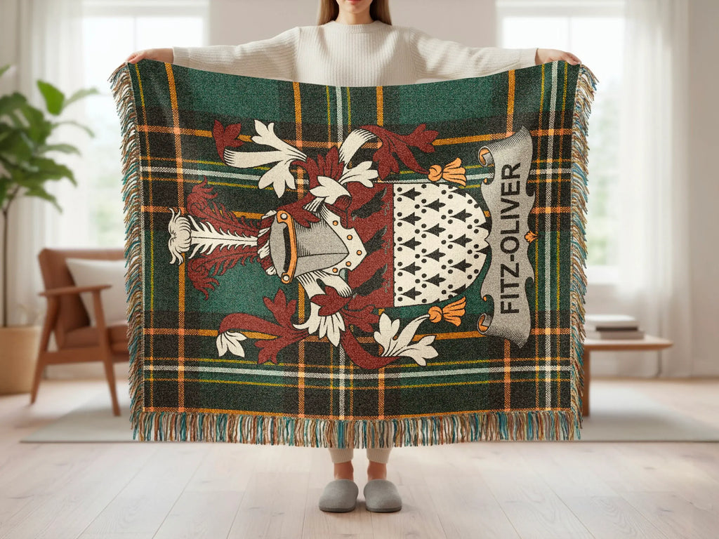 Tartan blanket with Fitz-Oliver crest held by a person.