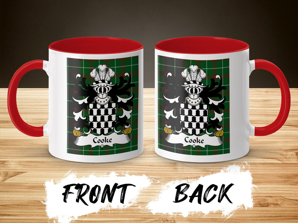 White mugs with red handles and interior, featuring the Cooke family crest on a green plaid background.