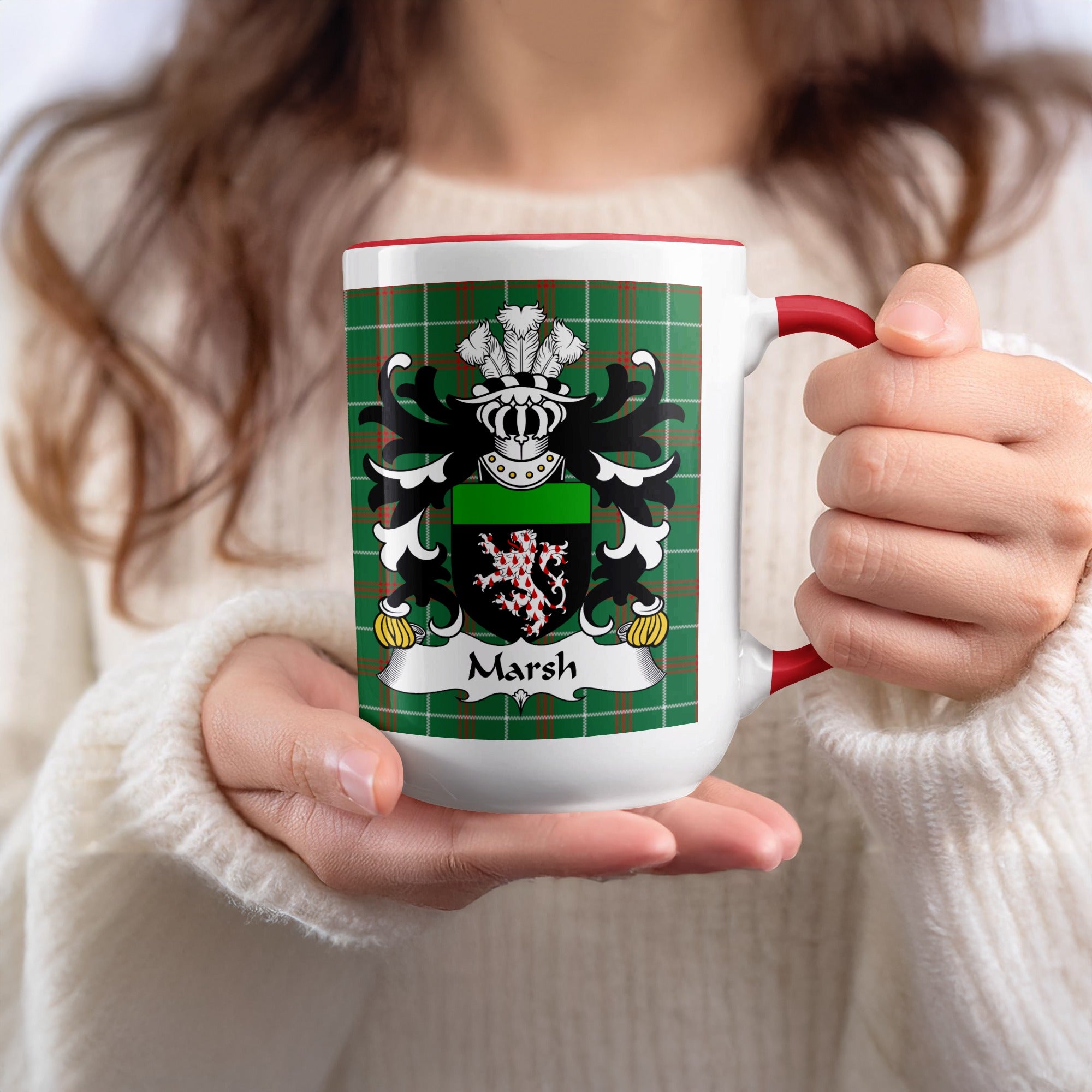 White mug with red handle featuring the Marsh family crest on a green plaid background.