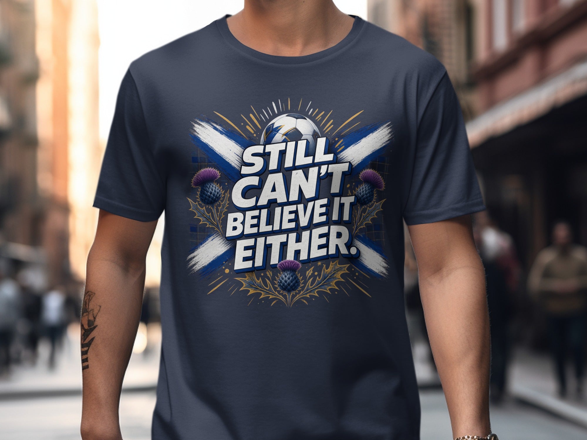 Dark blue t-shirt with Scottish flag, soccer ball, and "Still Can't Believe It Either."