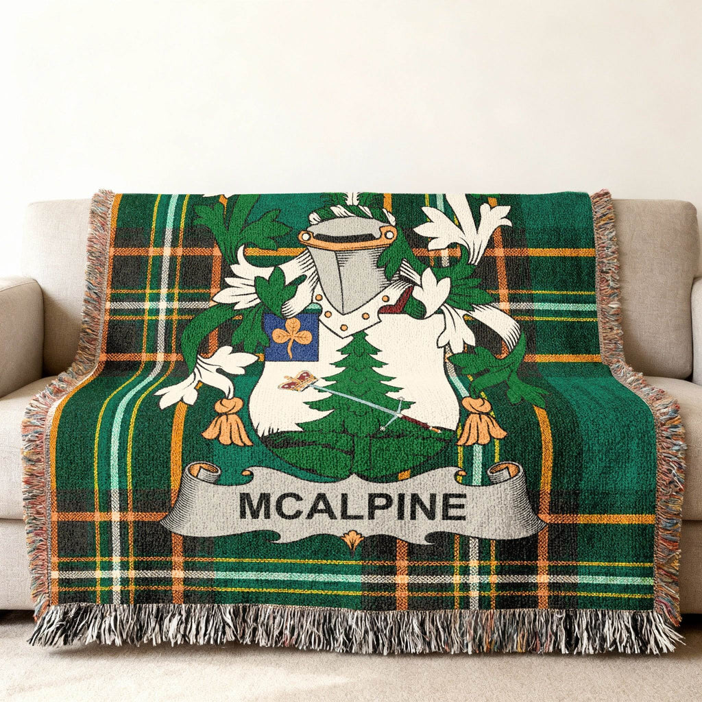 Green tartan blanket with McAlpine coat of arms and name.
