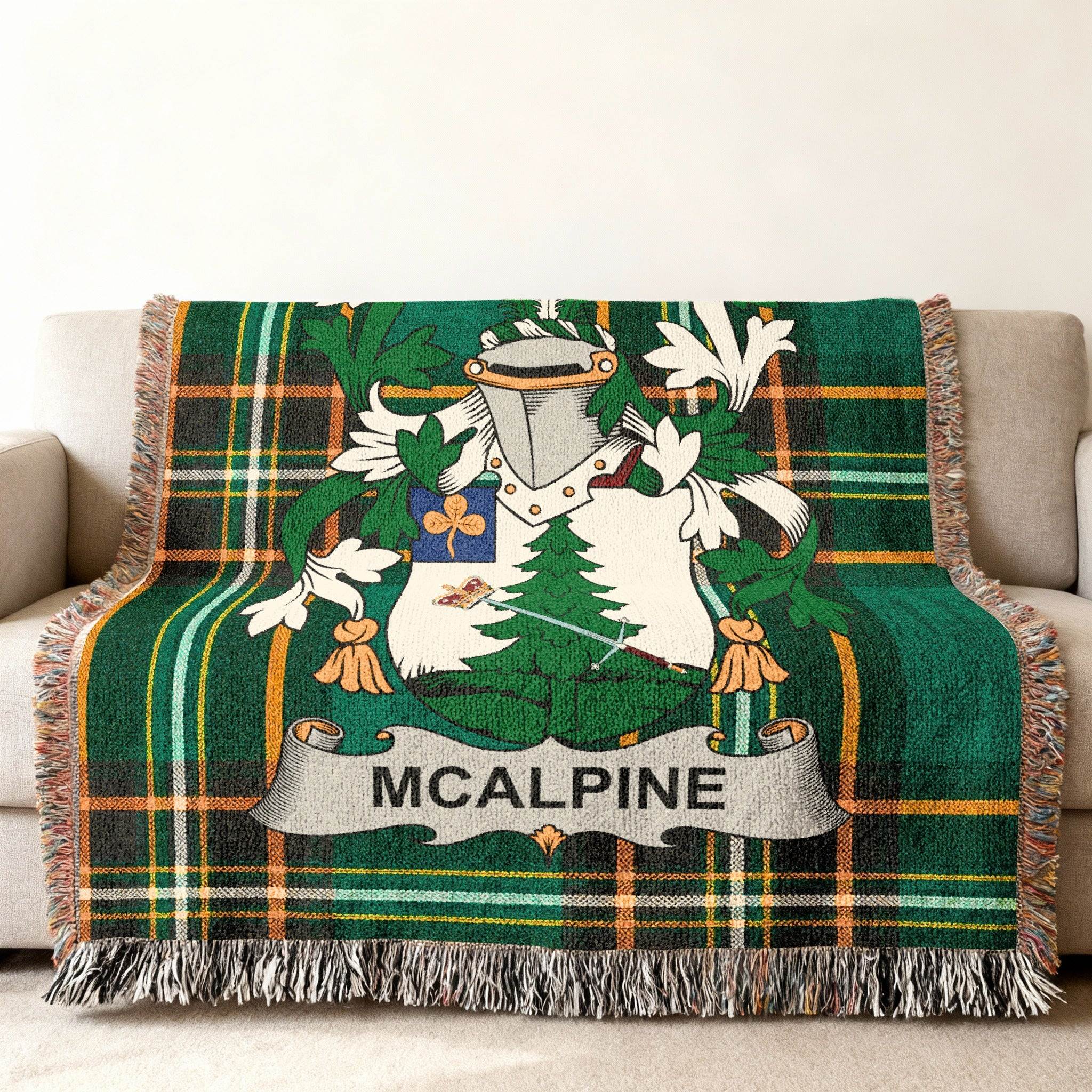 Green tartan blanket with McAlpine coat of arms and name.