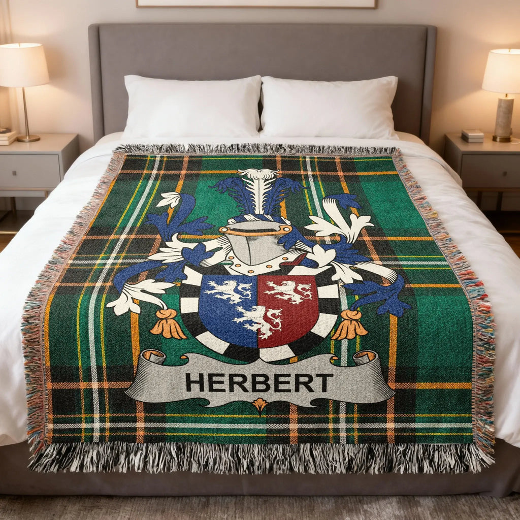 Green plaid blanket with Herbert family crest displayed on a bed.