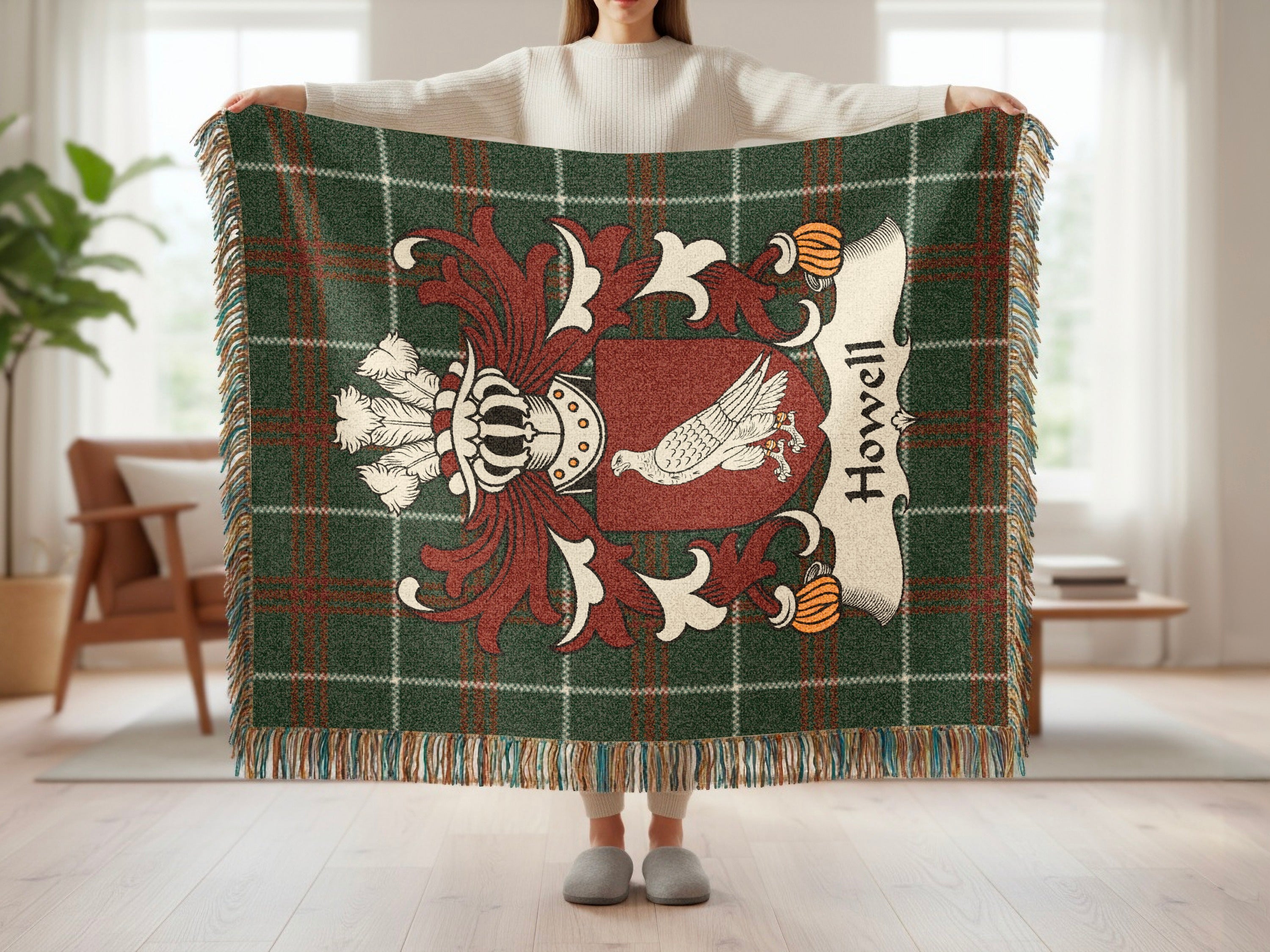 Green plaid throw blanket featuring a family crest with the name Howell.