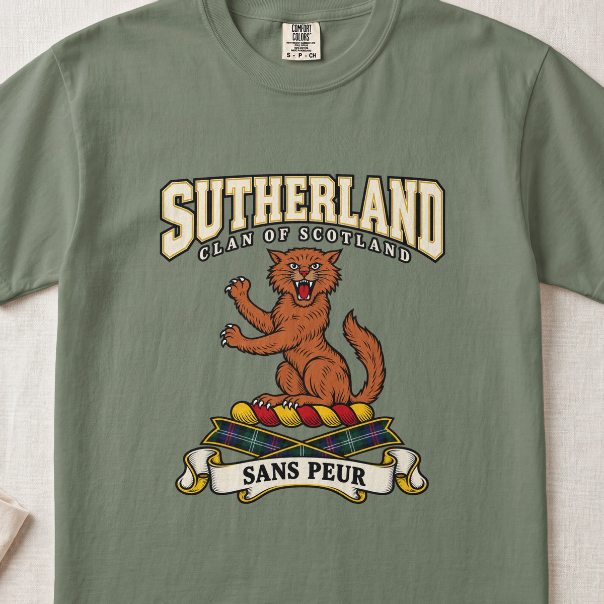 Sutherland graphic T-shirt in Moss green, front flat lay showing varsity lettering and orange-brown wildcat with raised paws and open mouth.