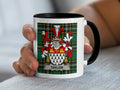 Mug featuring the Taylor family crest on a tartan background.