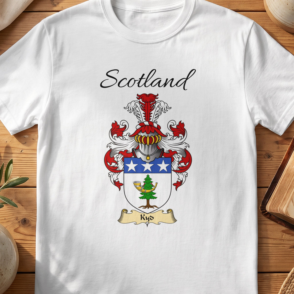 White Kyd Scottish family shield T-shirt featuring a blue top band with white stars above a green motif