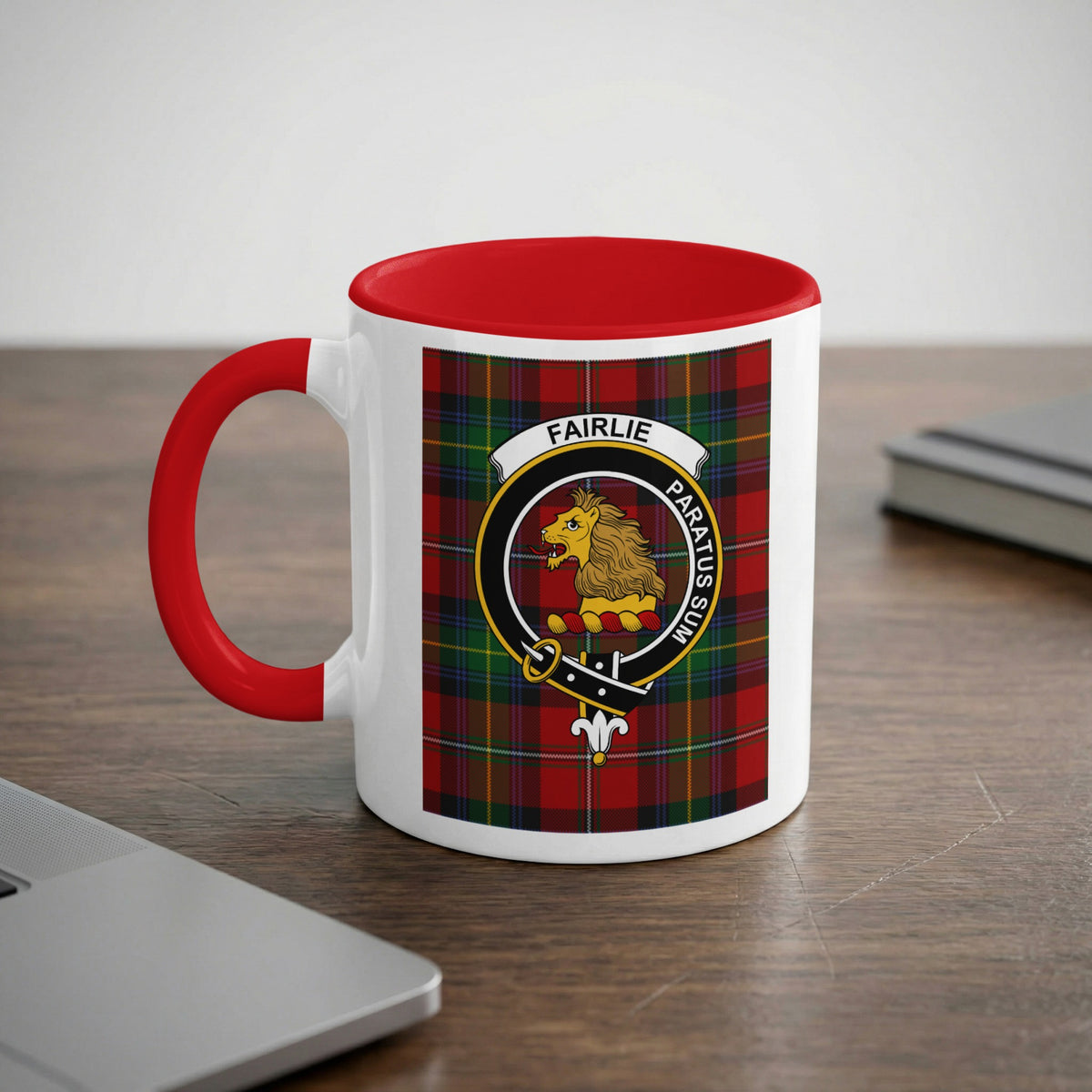 Fairlie Scottish family crest artwork on an 11 oz red accent mug with a tartan background