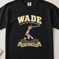 Wade Scottish clan T-shirt in Black, front view with an armoured arm holding a sword and motto design.