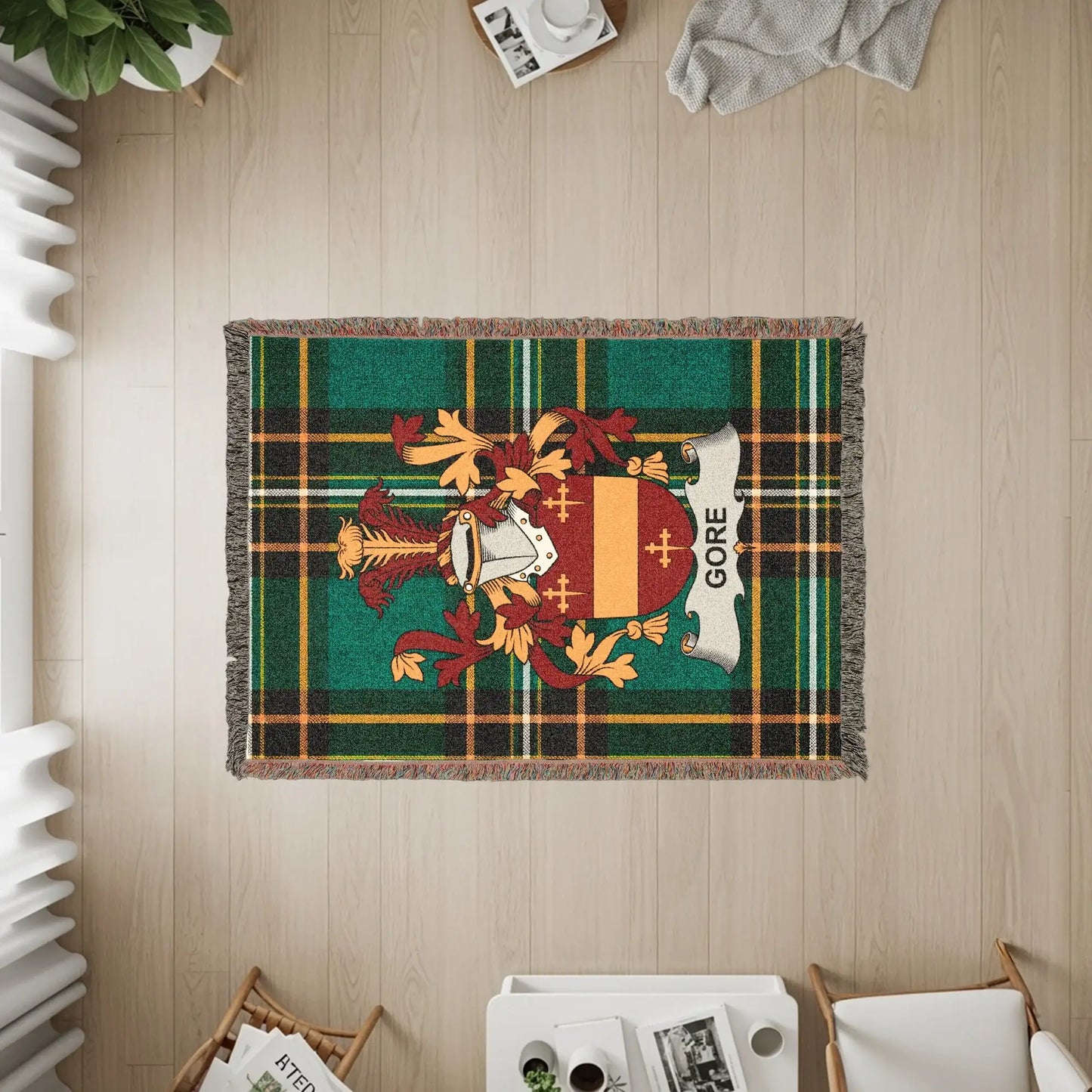 Gore clan crest on a green plaid throw blanket.