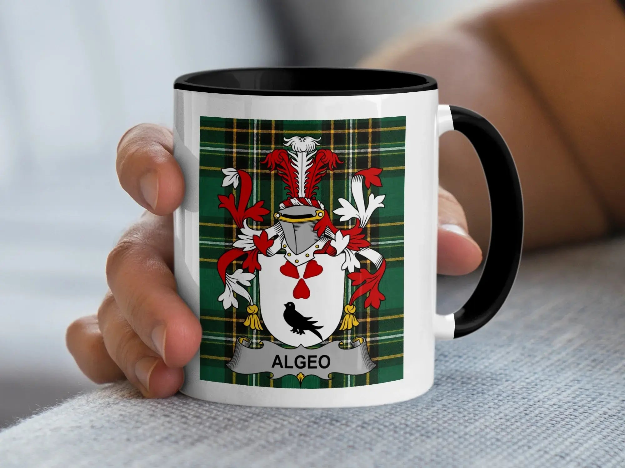 White mug with black rim featuring a family crest with the name ALGEO.