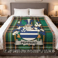 Tartan blanket with PEPPARD family crest on a bed.