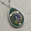 Morrison clan crest necklace with tartan background and motto.