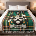 Green and black tartan blanket with Magee family crest in center.